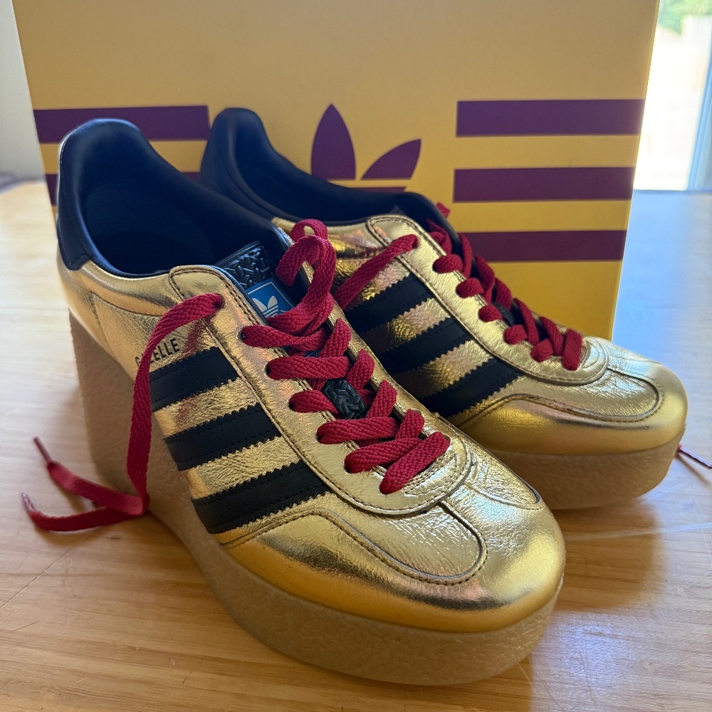 This is a Gucci x Adidas Gazelle Wedge sneaker in metallic gold